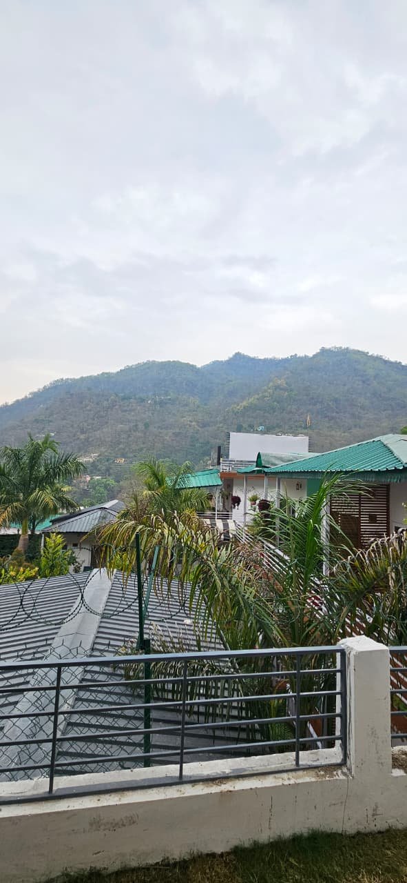 Cottage accommodation with green roofs and Himalayan mountain backdrop