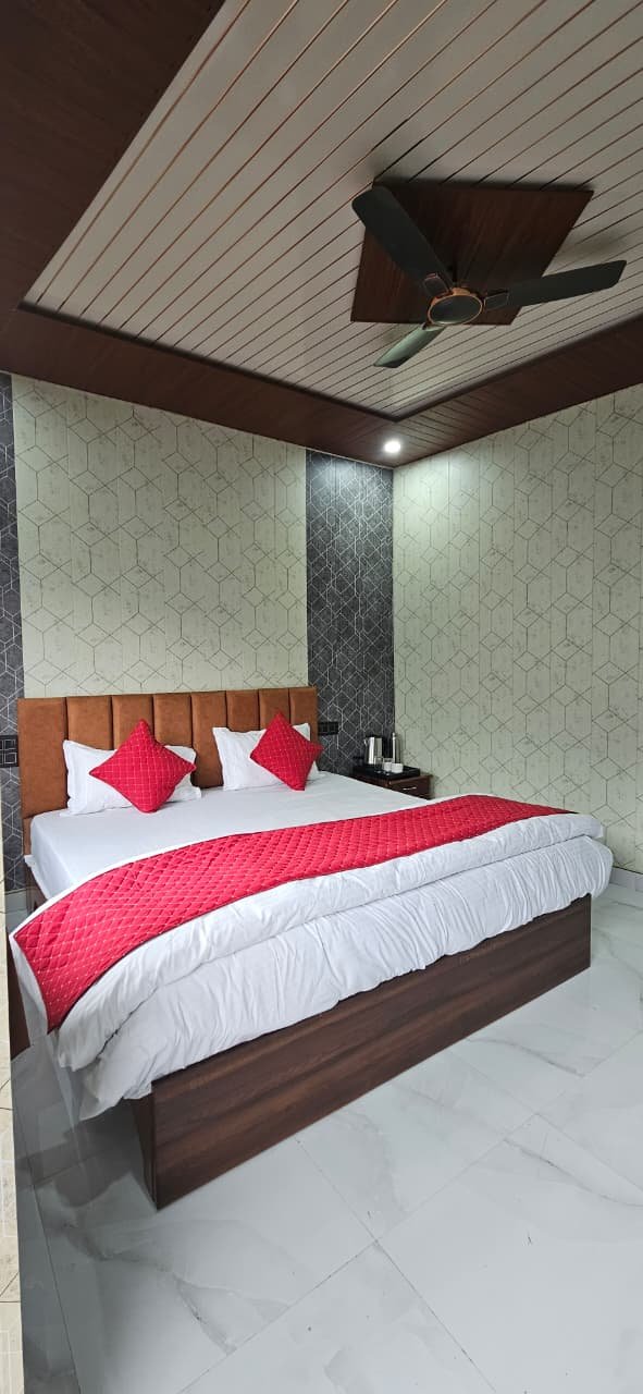 Family-friendly spacious bedroom with marble floor and ceiling fan