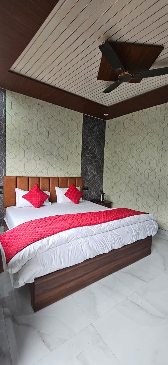 Guest bedroom with red bed runner and wood ceiling