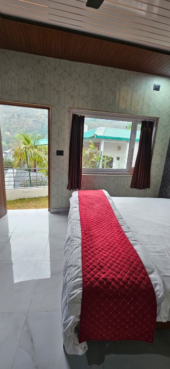 Room with view of valley and surrounding cottages