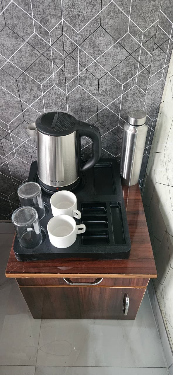 In-room tea and coffee amenity station with kettle and cups