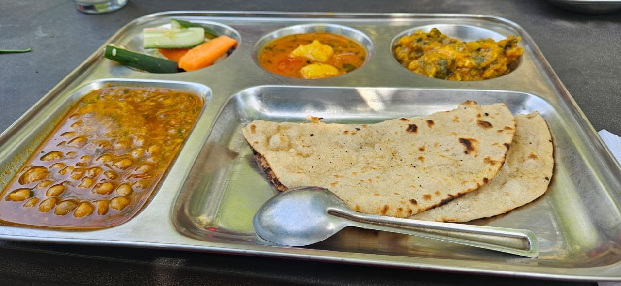 Pure vegetarian thali with chana, paneer curry, palak, rotis, and salad