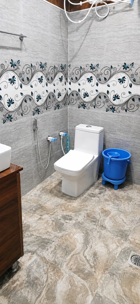 Well-maintained attached bathroom with hot water